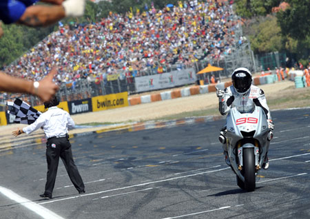 Lorenzo is so far ahead that he's just crossed the line with his hand off the throttle...
