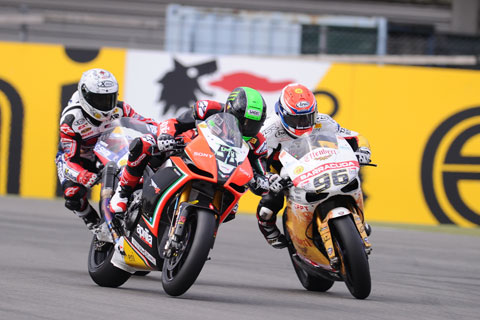 Nothing like a bit of argy-bargy... Eugene Laverty and Jakub Smrz dispute a bit of tarmac while Checa looks on. (Pic: Dunk Lamont)
