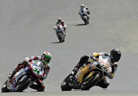 Maxime Berger sees off Davide Giugliano. But the track is drying out, and Berger has treaded tyres... (You can see them in the full size shot)